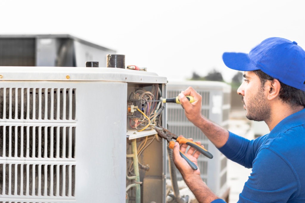 technician repairing aircon